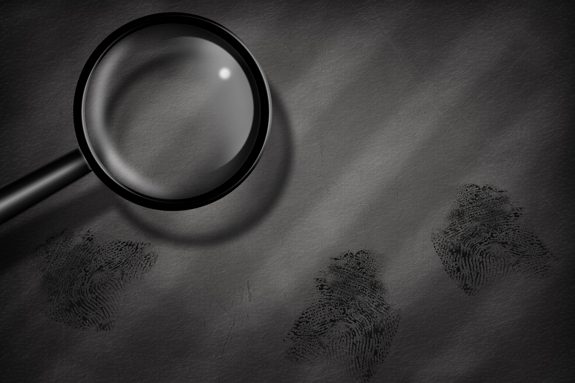 Criminology represented by a magnifying glass resting on a table with three fingerprints