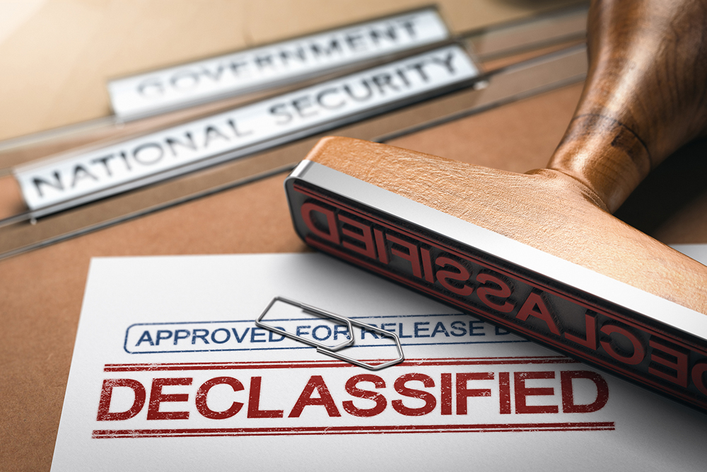 3D illustration of two folders and a rubber stamp with the word declassified printed on a document. Declassification of sensitive data and freedom of information concept.