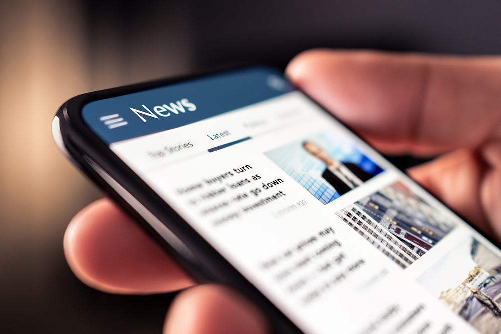 Media and Mass Communication: News online in phone. Reading newspaper from website. Digital publication and magazine mockup. Press feed with latest headlines in digital web portal.