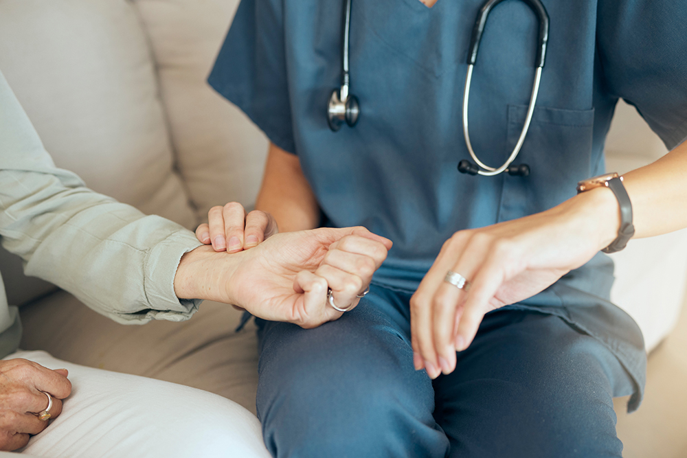Health Sociology: Closeup of an unrecognizable doctor offering their patient support during recovery. A loving unknown doctor measuring and taking the pulse of her patient.