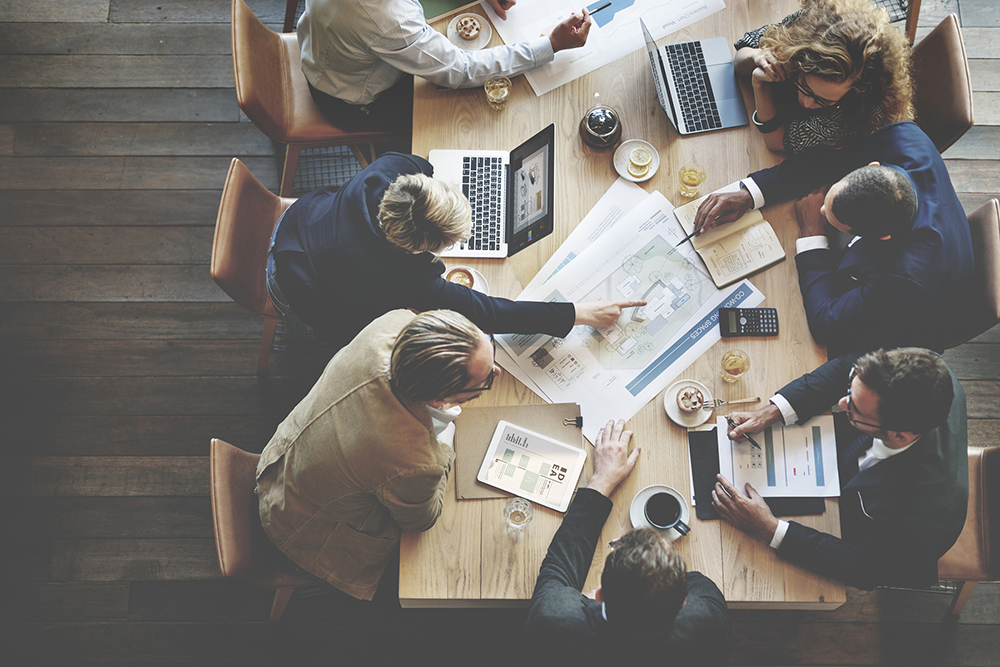 Education Policy: Educators meeting in a conference room discussing policy.