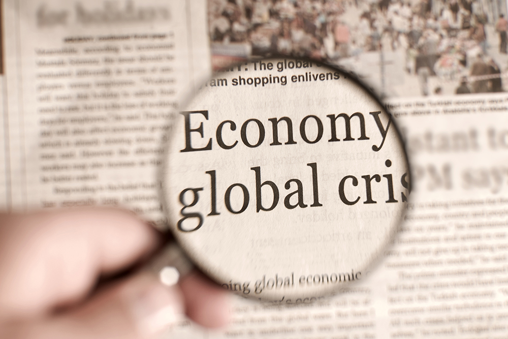 Political Economy: Image of newspaper with eyeglass enlarging title "Economy global crisis."