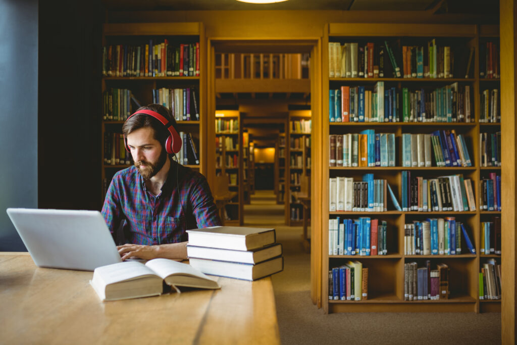 Hipster student studying in library